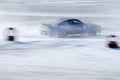 Blue car races along the course during the ice drifting competition Royalty Free Stock Photo